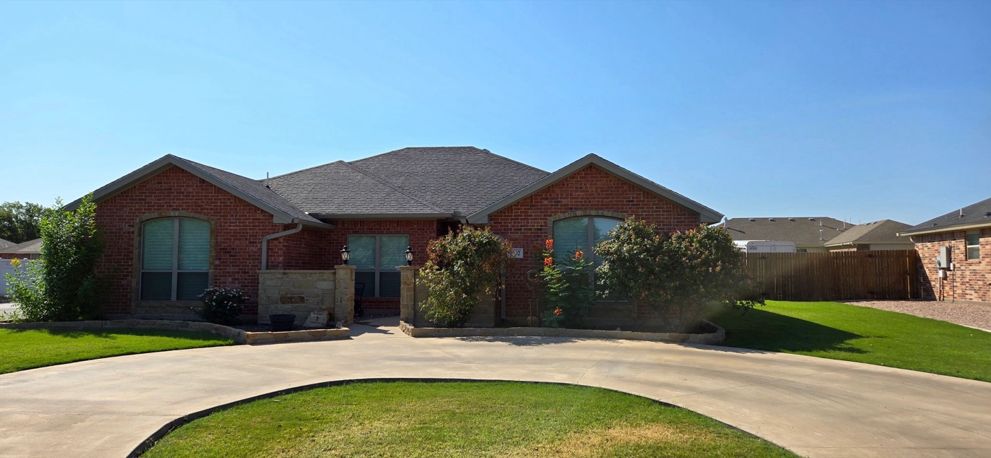 Single-story brick home with a circular drive in San Angelo, a common first home in the local market